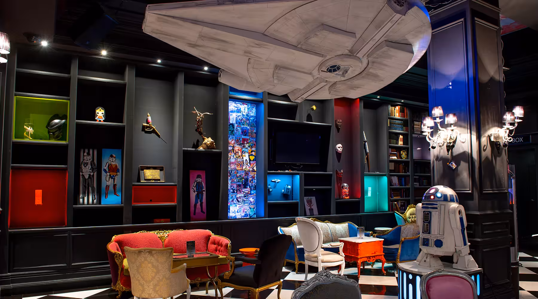 Millennium FANDOM Bar Themed Millennium Fandom Bar interior with sci-fi decor, collectible displays, colorful lighting, and lounge seating
